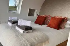 Usk glamping bedroom with bedding and towels provided