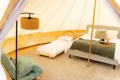 Woodland bell tents with a king size bed and two single futons