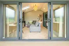 Snug cabin with an L-shaped sofa, TV, dining area and wood burner Snug cabin with an L-shaped sofa, TV, dining area and wood burner