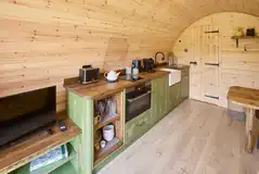 Kitchen with hob, oven/grill, microwave, coffee machine and fridge