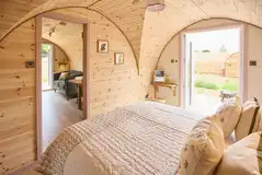 Campion king size bedroom with glass doors to outside