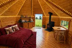 Cabin interior with double sofa bed, log burner and kitchenette Cabin interior with double sofa bed, log burner and kitchenette