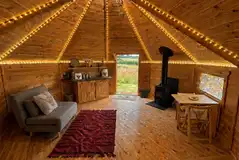 Cabin interior with double sofa bed, log burner and kitchenette Cabin interior with double sofa bed, log burner and kitchenette