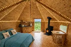 Cabin interior with double sofa bed, log burner and kitchenette Cabin interior with double sofa bed, log burner and kitchenette