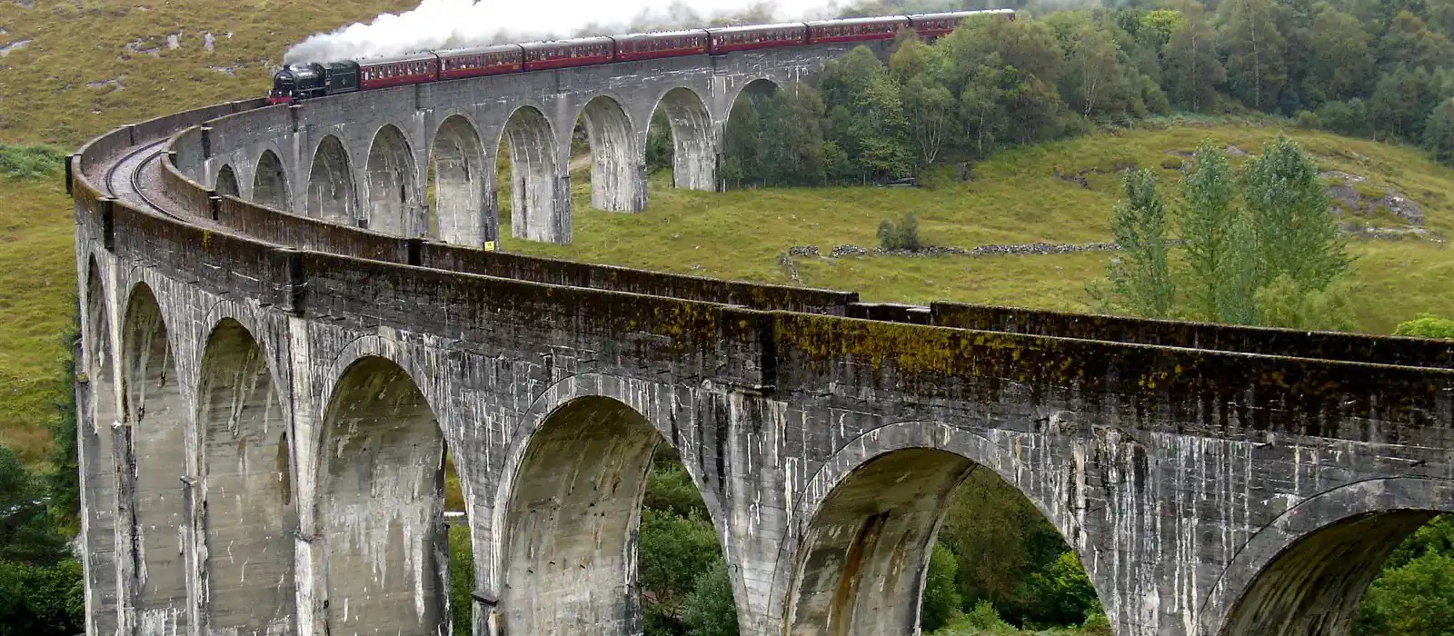 TheJacobite steam train passing over Glenfinnan Viaduct