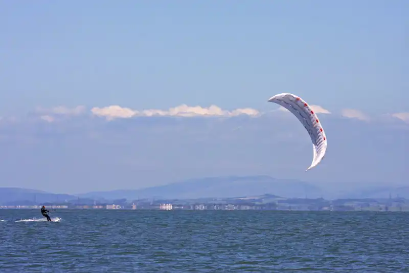 Kitesurfing on the sea having a microadventure